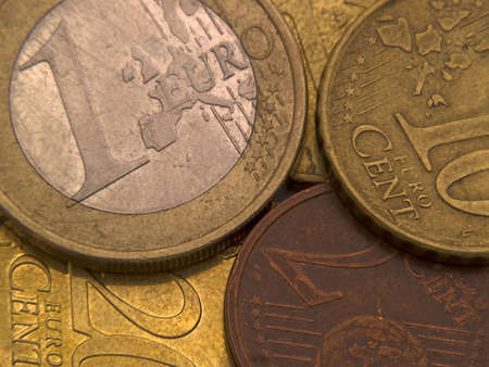Euro coins of different face-value laying on each other
