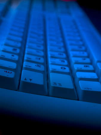 Keyboard close-up view in gloomy blue lightの写真素材