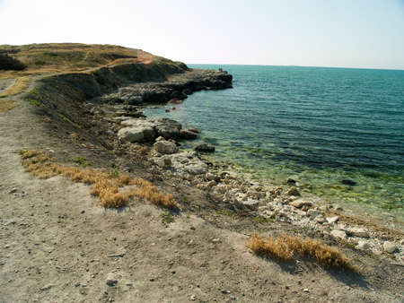 Deserted beach sea landscape with rocky seashoreの写真素材