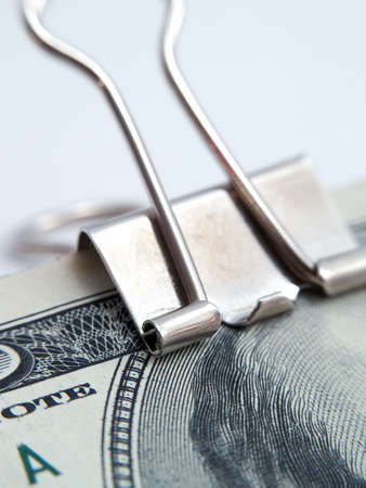 US dollars notes binded by paper-clip isolated whiteの写真素材