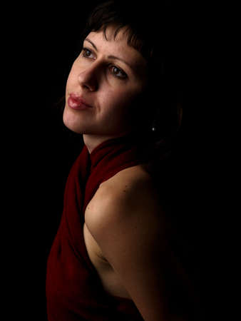 Ypung caucasian lady classic portrait black background red dress