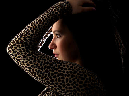 Young beautiful brunette woman portrait isolated on black