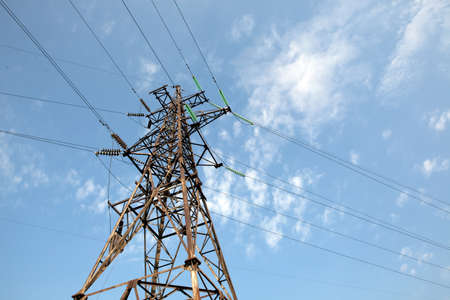 There is a power transmission line by an interesting angle of view under blue sky.