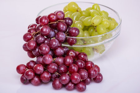 Grapes in a glass bowl on a white background. Close-up.