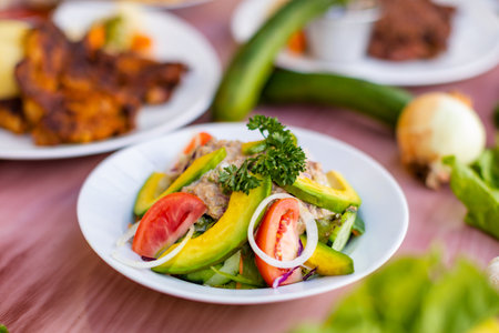Avocado salad with meat, tomato, onion and cucumber.の写真素材