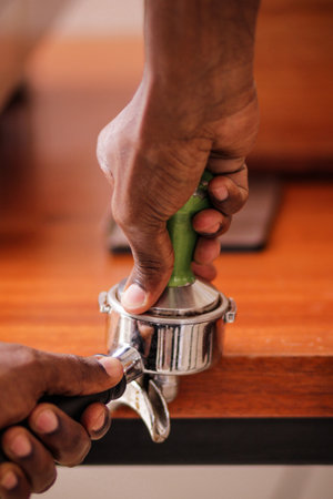 Close-up of a barista using a coffee machine to make espressoの写真素材