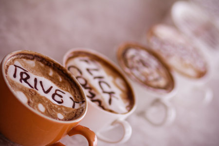 Two cups of cappuccino with the word love and chocolateの写真素材