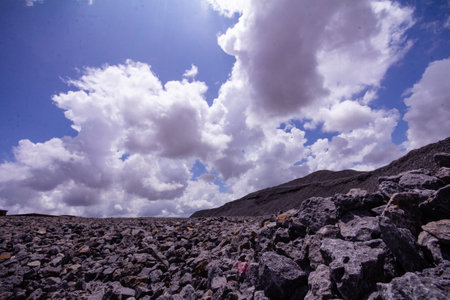 Beautiful mountain landscape with blue sky, clouds and rocky ground.の写真素材