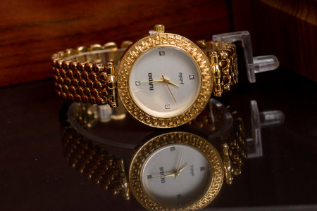 Luxury wristwatch on a mirror table. Selective focus.の写真素材
