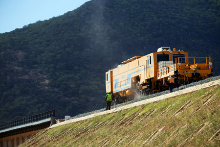 Train on the road in the mountains. View from above. High quality photo