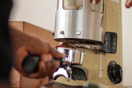 Coffee grinder making coffee in a coffee shop, close up