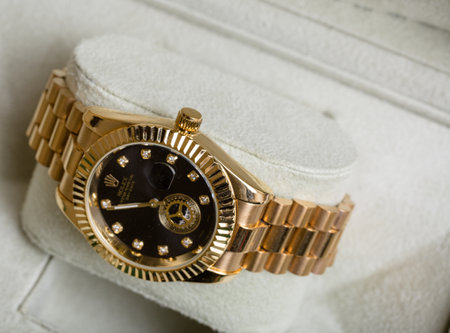 Luxury gold wristwatch in a white case close-upの写真素材
