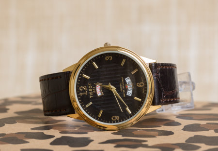 Luxury wrist watch on a background of camouflage fabric, closeupの写真素材