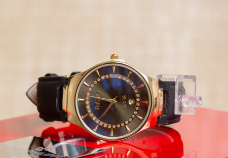 Close up of wristwatch on red table. Selective focus.の写真素材