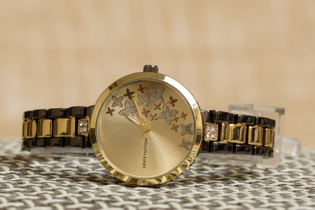Close up of gold wrist watch on a table. Selective focus.