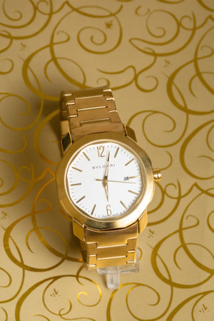 Luxury gold wrist watch on a yellow background. Close up.の写真素材