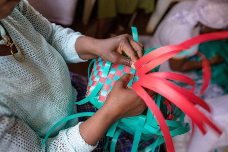 Close-up of african american woman weaving colorful ribbonsの写真素材