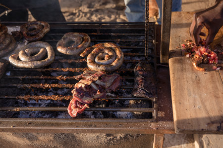 Barbeque with grilled meat and sausages on the grillの写真素材