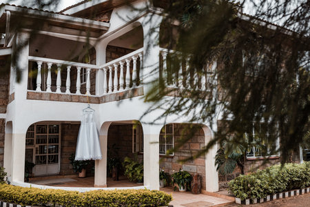 Beautiful wedding dress on the balcony of a house in the tropicsの写真素材