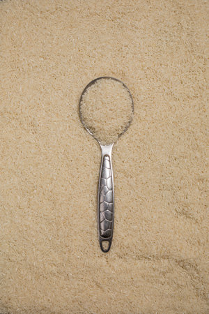 Sugar spoon on rice texture background. Food and drink concept.の写真素材