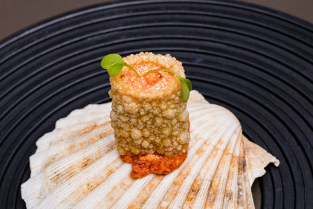 Japanese Cuisine - Scallop with caviar on a black background