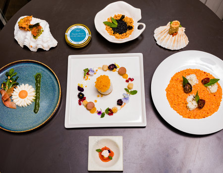 Porcelain plates with different types of appetizers on the tableの写真素材