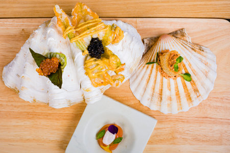 Sushi with salmon and caviar on a wooden table, top view