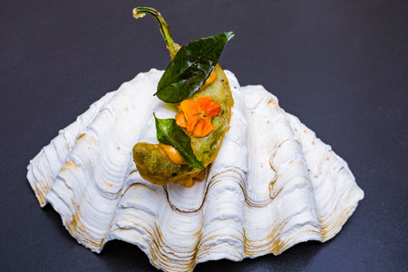 Delicious gourmet dish on a black background. Toned.