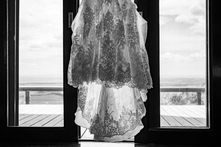 Wedding dress on the window. Black and white photo.