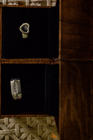 wedding rings in a box on a wooden background. close-up