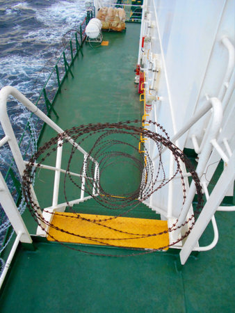 View of the vessel hardening on board ships using razor wire and wire fencing, to stop pirates from...