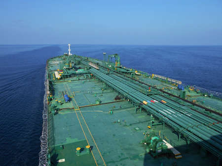 A ship is underway at sea in the evening, view from the bridge wingsの写真素材
