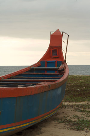 Open type fishing boat secured at beach sand