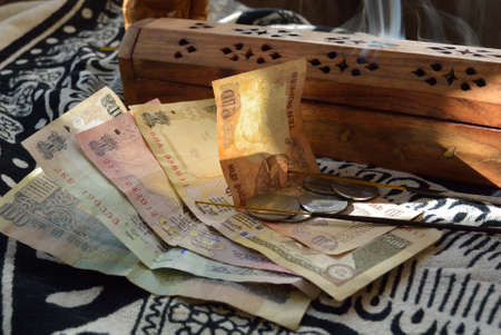 Indian rupees and incense burnerの写真素材