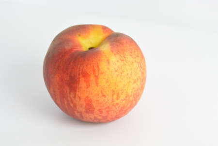 one ripe peach lies on the tableの写真素材