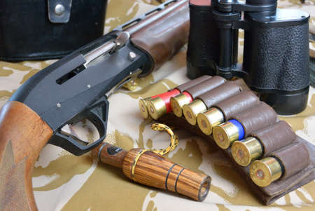 some large-caliber ammoes in the ammo bag, binoculars, gun and duck callの写真素材