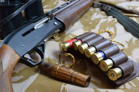 some large-caliber ammoes in the ammo bag and binoculars gun and duck callの写真素材