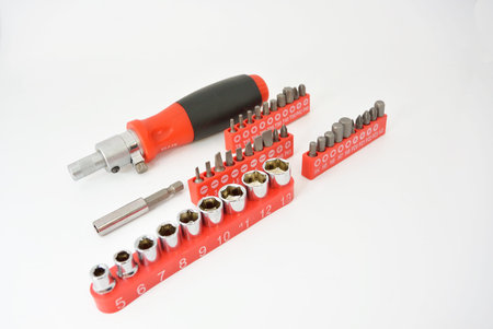 screwdriver with red black handle and nozzles bits
