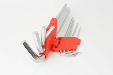 many stailnless steel hexagons in red plastic caseの写真素材