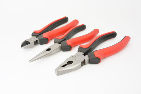 some pliers tools with red rubber handle