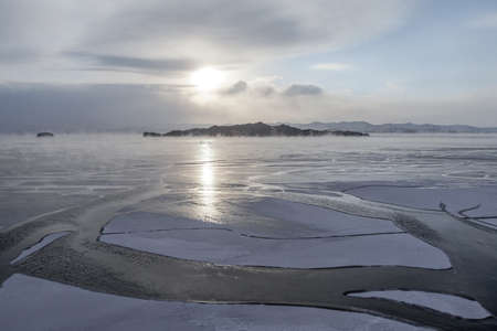 Ice formation process on lake in winterの写真素材