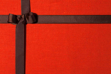 Orange linen cloth and brown ribbon with bowの写真素材