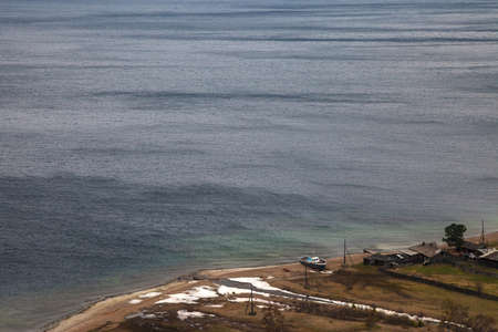 Water background with little coastal village on Ð° cloudy dayの写真素材