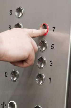 white man pushing buttons on an elevator