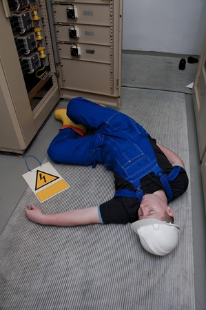 electrician electrocuted - wounded man lying on the groundの写真素材