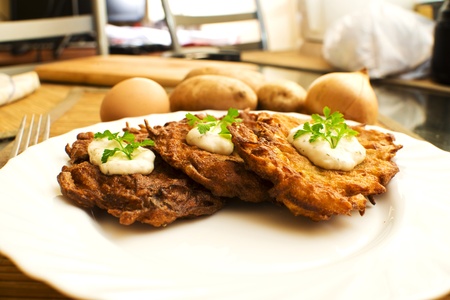 potato pancake with sour cream and parsleyの写真素材