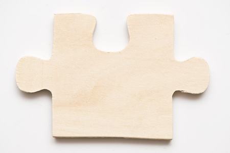 wooden puzzle piece on a white backgroundの写真素材