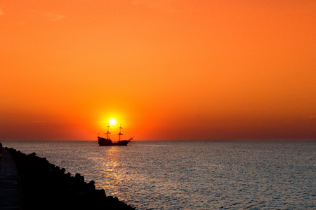 sunset - sailing ship silhouette on the sunset backgroundの写真素材