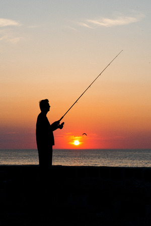 angler silhouette against the sunsetの写真素材