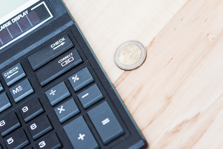 black calculator and 2-euro coinの写真素材